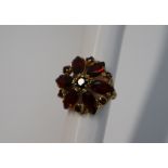 A garnet set dress ring,