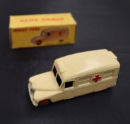 A Dinky Toys diecast model of a Daimler Ambulance, with a cream body, red crosses and red hubs, No.