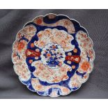 A Japanese Imari plate with a scalloped edge,