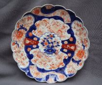 A Japanese Imari plate with a scalloped edge,