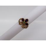 A suffragette type ring, set with citrines, amethysts and an emerald,