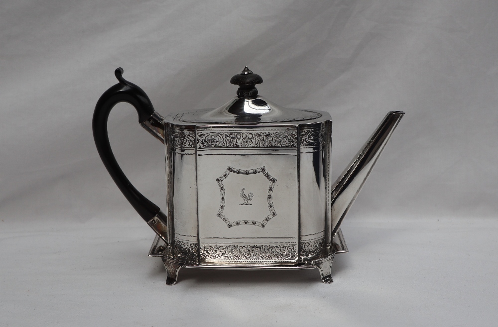 A Victorian silver teapot of rectangular form, decorated with bands of...