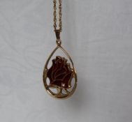 A 9ct gold pendant produced for the "Year of the Rose, RNRS 1976" on a yellow gold chain,