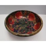 A William Moorcroft pottery pedestal bowl decorated in the pomegranate pattern to a mottled green