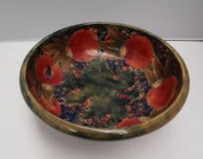 A William Moorcroft pottery pedestal bowl decorated in the pomegranate pattern to a mottled green