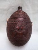 A coconut flask, carved with a unicorn and lion pierced hearts, vases of flowers, a face etc,