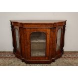 A Victorian walnut credenza, the shaped top above a central glazed door and glazed side doors,