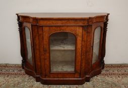 A Victorian walnut credenza, the shaped top above a central glazed door and glazed side doors,