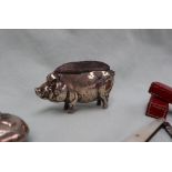 A silver pin cushion in the form of a pig, Birmingham, Henry Matthews, date letter rubbed,