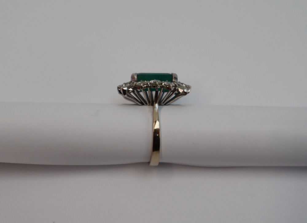 An emerald and diamond cluster ring, the central emerald cut emerald approximately 12mm x 9mm, - Image 4 of 7