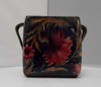 A William Moorcroft pottery twin handled box decorated in the Spanish pattern,
