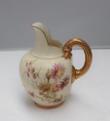A Royal Worcester porcelain flatback jug, decorated with flowers to an ivory ground,