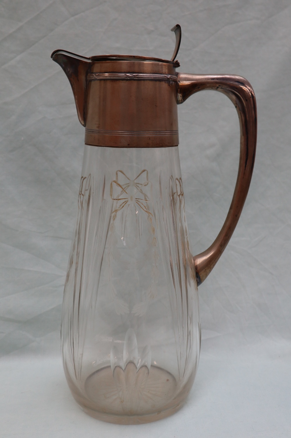 A continental white metal and glass jug,