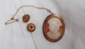 A shell cameo brooch depicting a maiden in profile,
