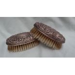 A pair of Elizabeth II silver backed hair brushes decorated with scrolls and leaves, Birmingham,