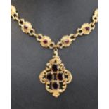 A 9ct yellow gold necklace, the pendant drop set with four oval faceted garnets,