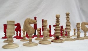 A 19th century bone chess set, barleycorn pattern, one side natural the other stained red, King 8.