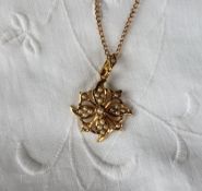 A seed pearl floral setting pendant marked 15ct,