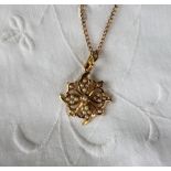 A seed pearl floral setting pendant marked 15ct,