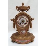 A 19th century French gilt bronze mantle clock, with a twin handled vase surmount,
