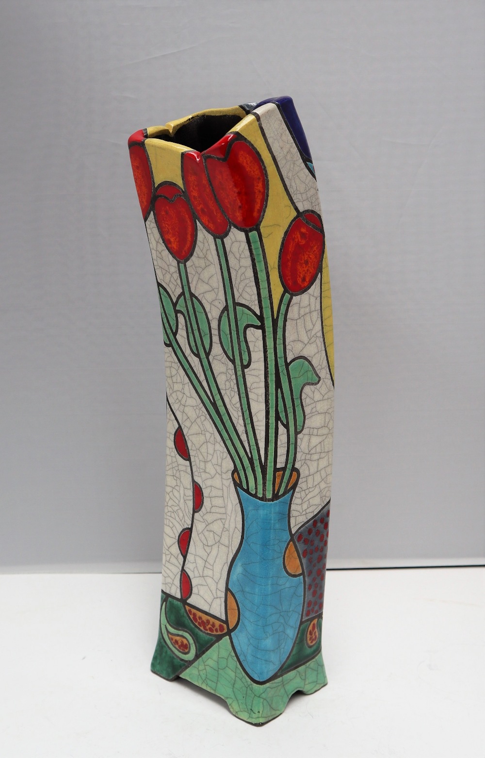 A Tony White leaning raku vase decorated with tulips and a nude figure, titled "Tulips,