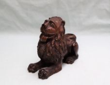 A bronze model of a recumbent lion,