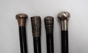 A George V silver topped walking stick, the silver knob handle decorated with scrolling leaves,