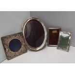 A George V silver photograph frame of oval form with line decoration and shaped edges, Chester,