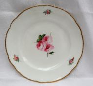 A Nantgarw porcelain plate, with a shaped gilt rim,