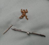 A yellow metal stick pin in the form of a Frog, marked 15, 1.