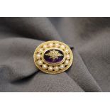 A 9ct yellow gold brooch of oval form,