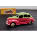 A Dinky Toys diecast model of an Austin Devon Saloon, with a two tone highline body,