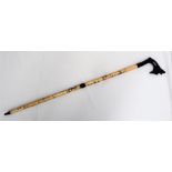 A Japanese bone sectional walking stick, with an ebony dragon carved handle,
