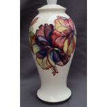 A Moorcroft pottery table lamp, decorated in the Hibiscus pattern to a cream ground, impressed mark,