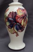 A Moorcroft pottery table lamp, decorated in the Hibiscus pattern to a cream ground, impressed mark,