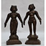 A pair of Indian bronze figurines in traditional dress on square bases,