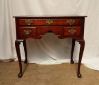 An 18th century oak lowboy,