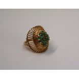 A 14ct yellow gold dress ring, set with a cluster of light green stones, possibly peridot,
