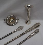 Three silver handled button hooks,