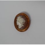 A shell cameo brooch depicting a head in profile,