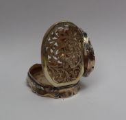 A Victorian silver vinaigrette, of oval lobed form, decorated with scrolls and leaves, initialled,