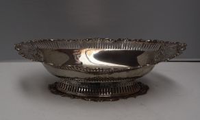 An Edward VII silver pedestal dish of pointed oval form decorated with flower heads and "C" scrolls