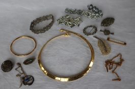 A yellow metal bangle together with yellow metal necklaces and assorted costume jewellery