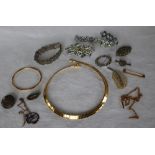 A yellow metal bangle together with yellow metal necklaces and assorted costume jewellery