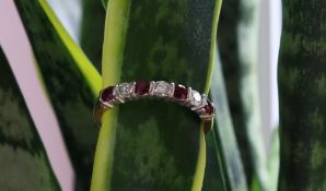 A ruby and diamond half eternity ring set with four rubies and three round brilliant cut diamonds