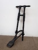 A Victorian ebonised pine boot jack, with a turned handle and uprights,