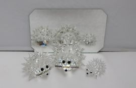 Swarovski crystal -- three hedgehogs of graduating sizes on a mirror
