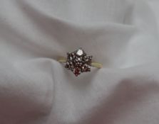 A diamond cluster ring set with seven round brilliant cut diamonds,