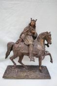 A bronze model of a king on horseback, with a sword in his left hand and right hand open,