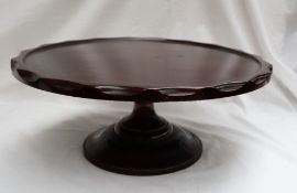 A Victorian mahogany Lazy Susan, the circular top with gouged edge, on a capstan shaped pedestal,